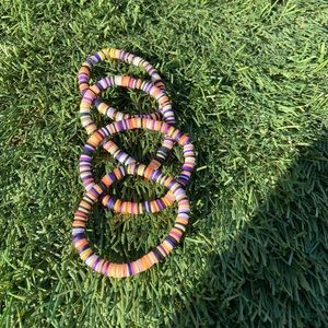 Orange,purple,black,yellow bracelets